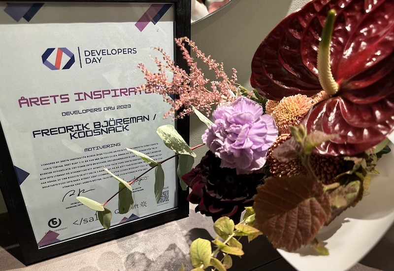 Framed award diploma, plus flowers