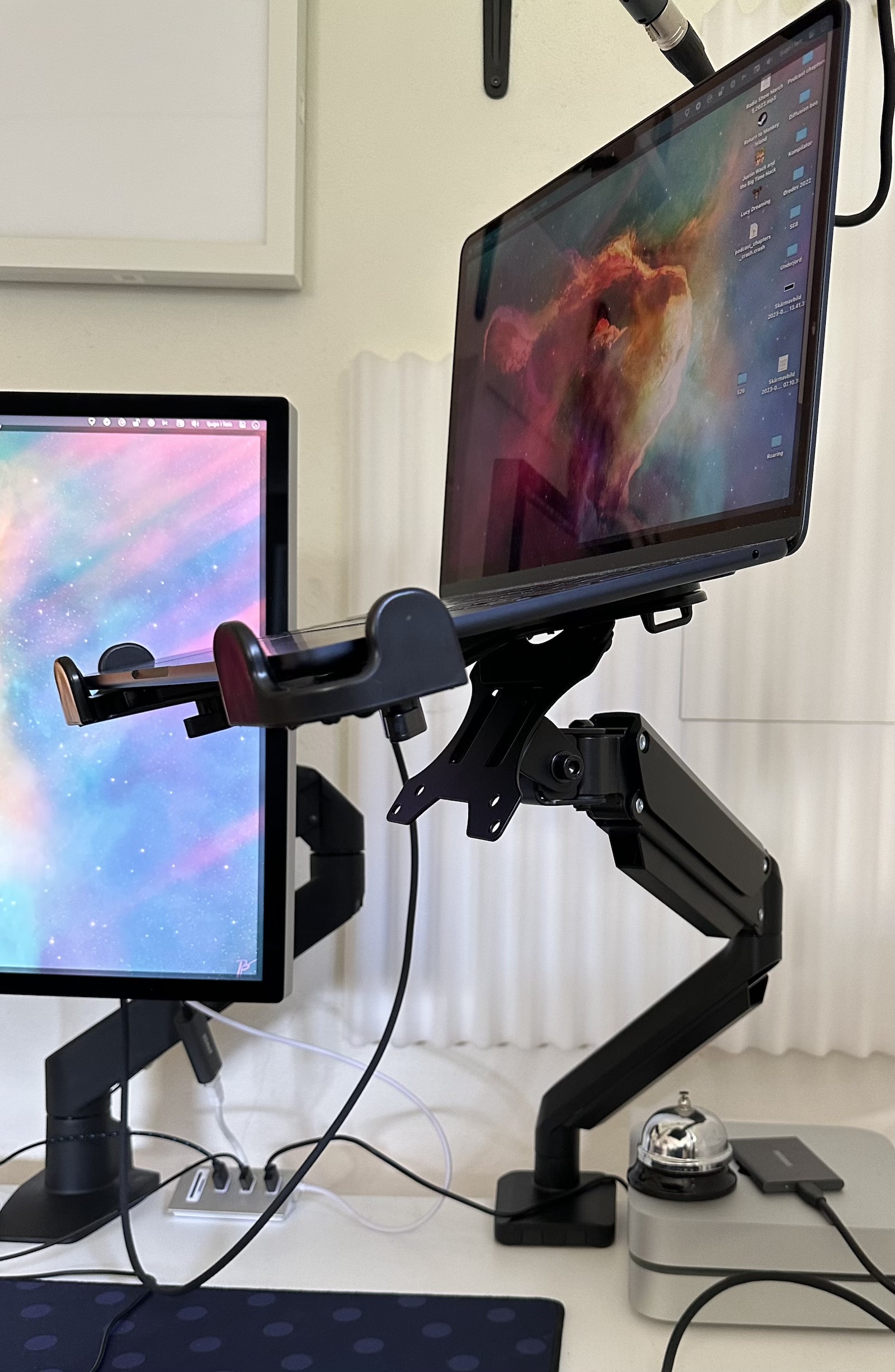 Laptop on VESA arm, seen from side to show the arm more cleary